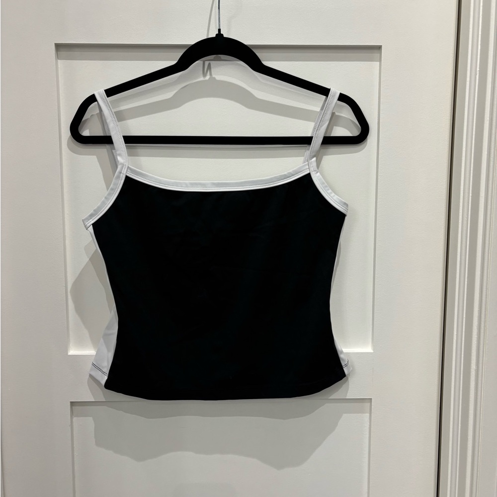 White fox tank top with black front and white sides. Never worn